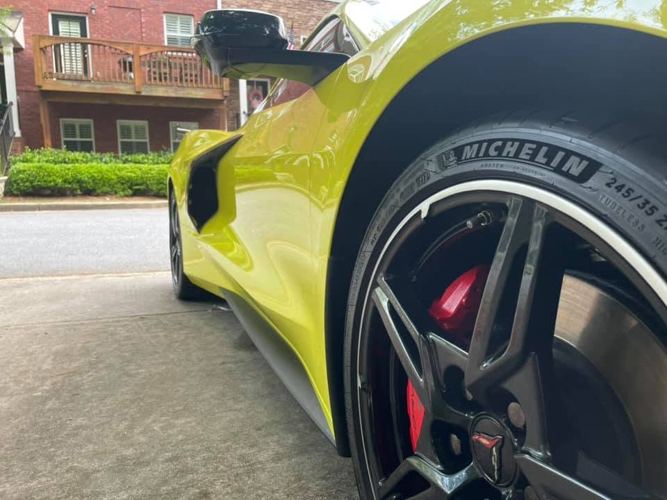 Close-up of a detailed wheel, tire and glossy body panel