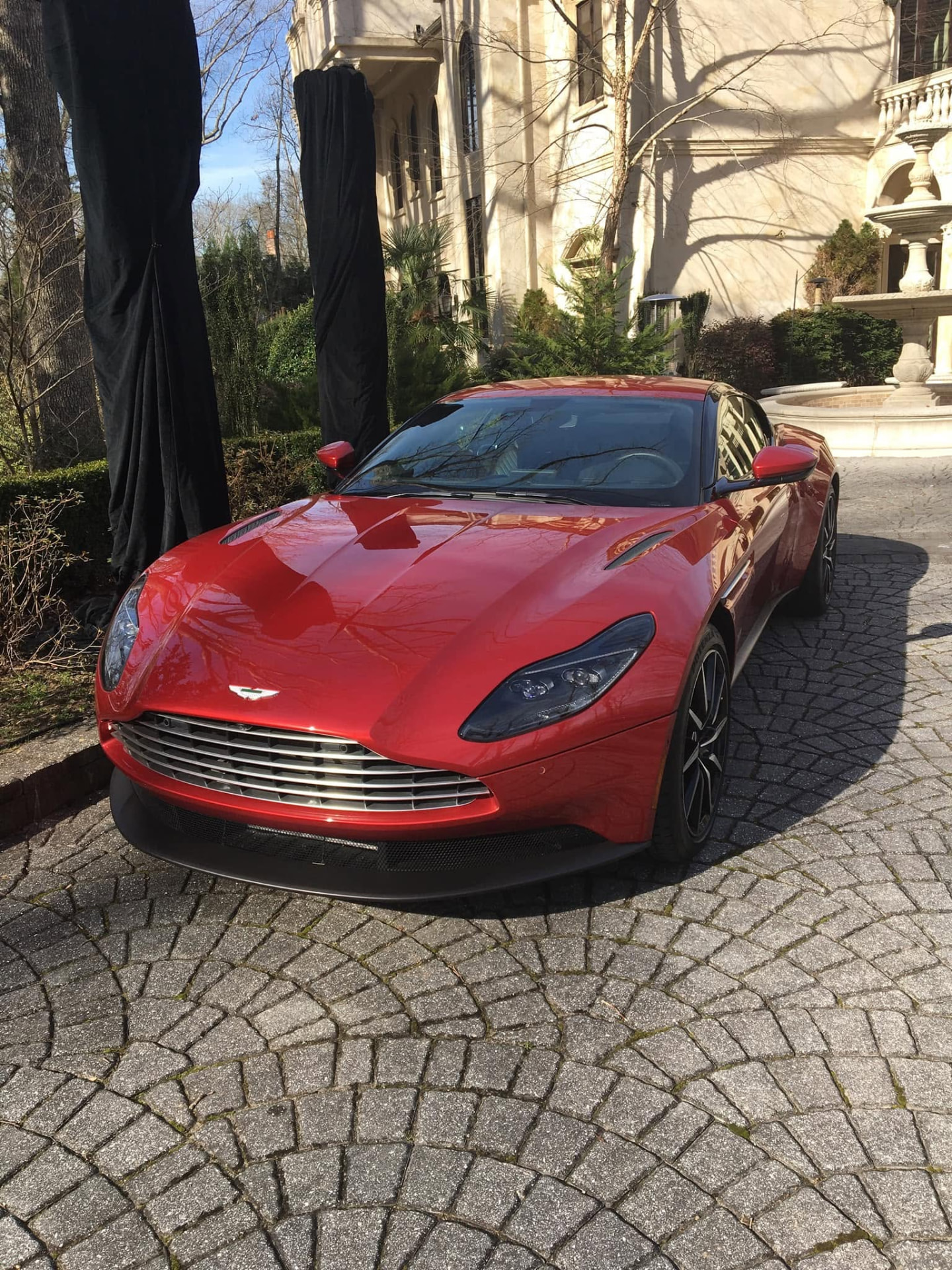 Red sports car with mirror-gloss polished paint after detailing